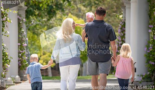 Image of Young Caucasian Family Taking A Walk In The Park