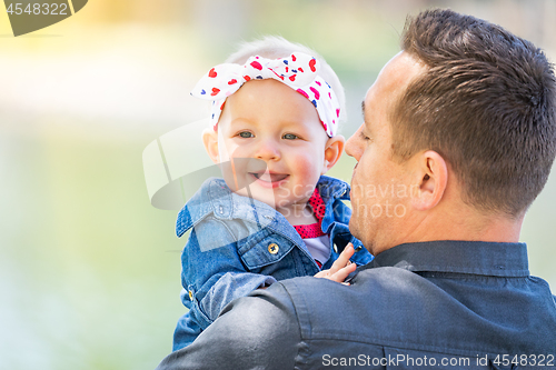 Image of Young Caucasian Father and Baby Girl At The Park