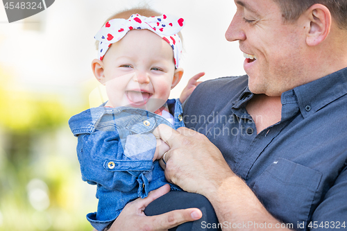 Image of Young Caucasian Father and Baby Girl At The Park