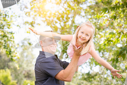 Image of Young Caucasian Father and Daughter Having Fun At The Park