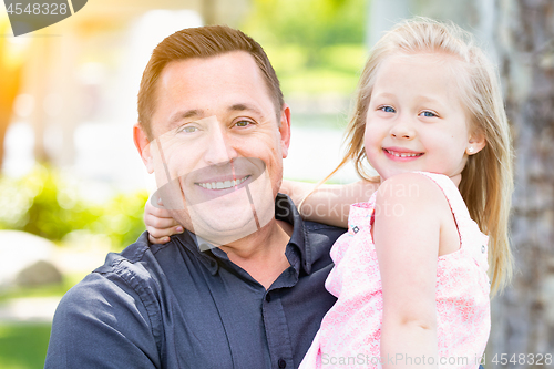 Image of Young Caucasian Father and Daughter Having Fun At The Park