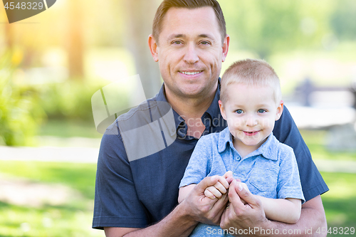 Image of Young Caucasian Father and Son Having Fun At The Park