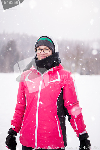 Image of Portrait of young woman on snowy winter day
