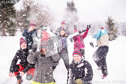 Image of group of young people throwing snow in the air