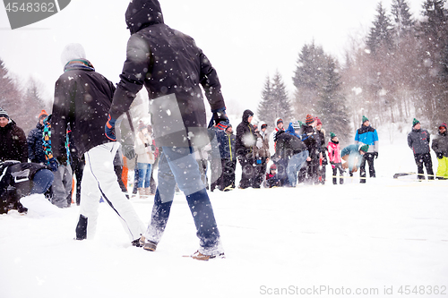 Image of group of young people having a running in bag competition