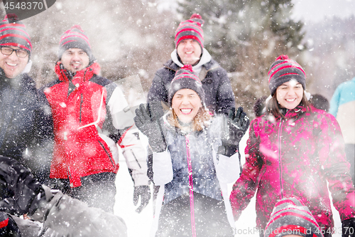 Image of group of young people throwing snow in the air