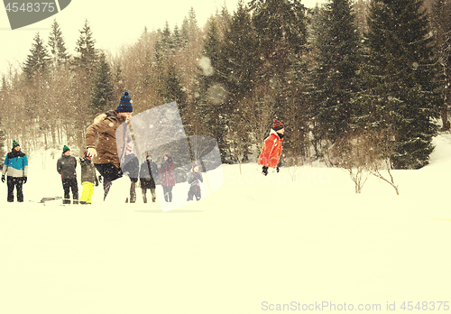 Image of group of young people having a running in bag competition