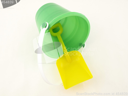 Image of Plastic bucket and shovel laying on its side