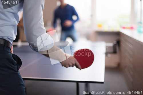 Image of startup business team playing ping pong tennis