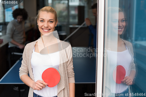 Image of startup business team playing ping pong tennis