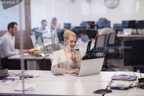 Image of businesswoman using a laptop in startup office