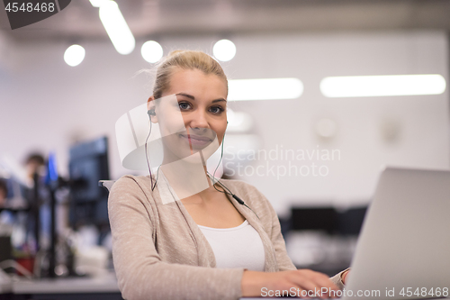 Image of businesswoman using a laptop in startup office