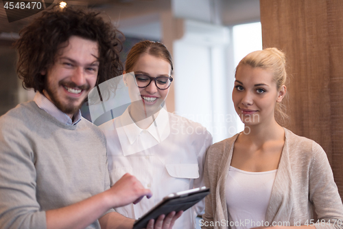 Image of Business People Working With Tablet in startup office