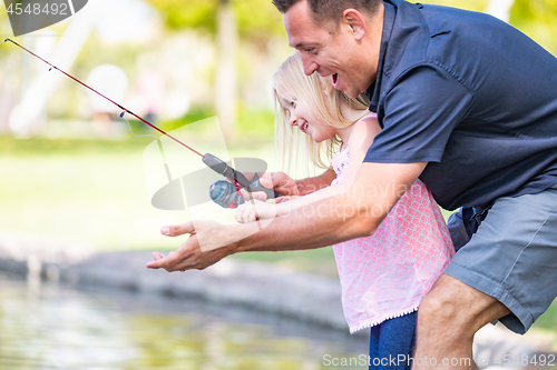 Image of Young Caucasian Father and Daughter Having Fun Fishing At The La