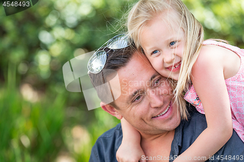 Image of Young Caucasian Father and Daughter Having Fun At The Park