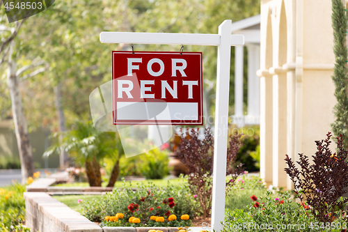 Image of Red For Rent Real Estate Sign in Front House