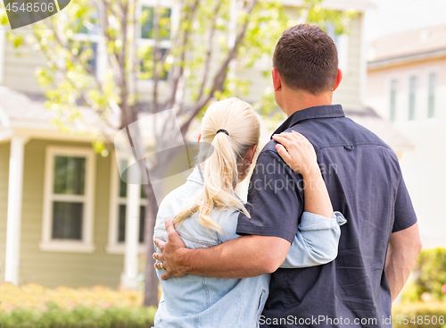 Image of Happy Caucasian Couple Facing Front of House
