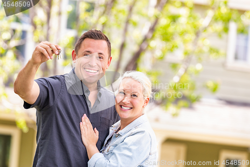 Image of Caucasian Couple in Front of House with Keys