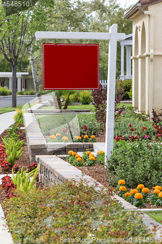 Image of Blank Sale Real Estate Sign in Front of House