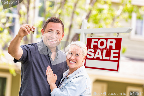 Image of Caucasian Couple in Front of For Sale Real Estate Sign and House