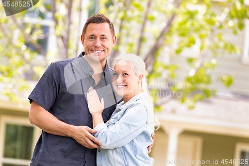 Image of Happy Caucasian Couple in Front of House