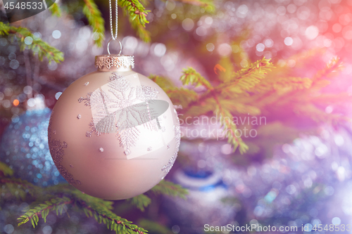 Image of Christmas-tree decoration bauble on decorated Christmas tree bac