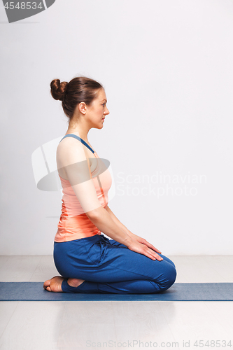 Image of Woman in Hatha yoga asana Vajrasana