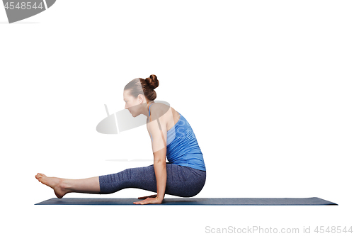 Image of Woman doing Hatha asana Utpluti dandasana - lifted stuff pose