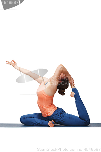 Image of Woman doing Hatha yoga asana Eka pada rajakapotasana