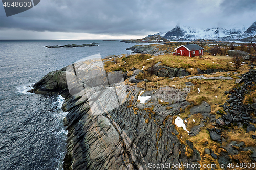 Image of Clif with traditional red rorbu house on Lofoten Islands, Norway