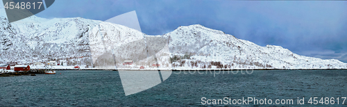 Image of Norwegian fjord with red rorbu houses in Norway in winter