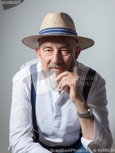 Image of senior male portrait with a straw hat