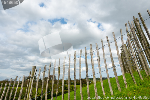 Image of green grass meadow fence in Ireland