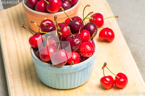 Image of Red ripe cherries in ceramic bowls