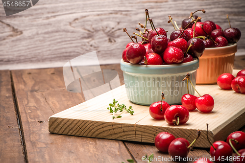 Image of Red ripe cherries in ceramic bowls