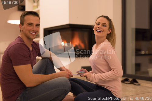 Image of Young Couple using digital tablet on cold winter night