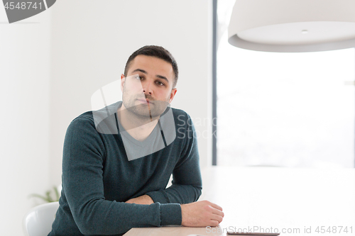 Image of Young casual businessman using smartphone