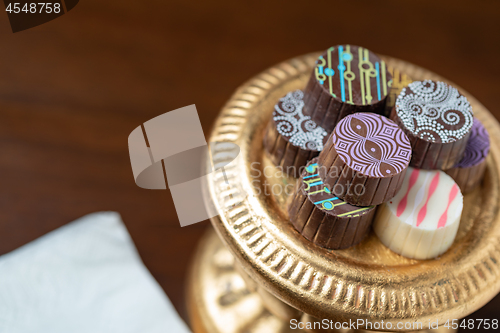 Image of Artisan Fine Chocolate Candy On Gold Pillar Serving Dish