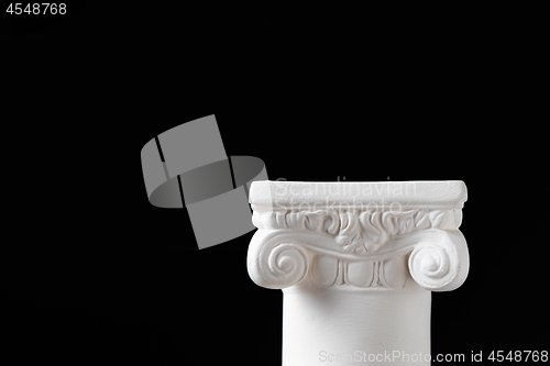 Image of White Ionic Design Column on Dark Background