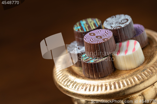 Image of Artisan Fine Chocolate Candy On Gold Pillar Serving Dish