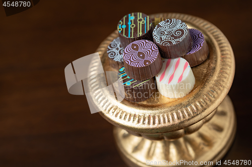 Image of Artisan Fine Chocolate Candy On Gold Pillar Serving Dish