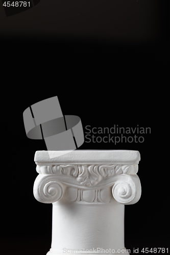 Image of White Ionic Design Column on Dark Background