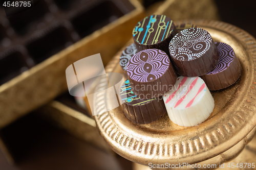 Image of Artisan Fine Chocolate Candy On Gold Pillar Serving Dish