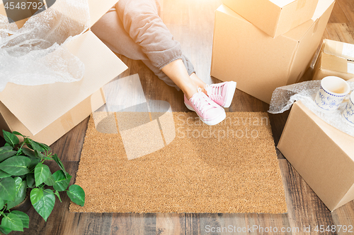 Image of Woman Wearing Sweats Relaxing Near Home Sweet Home Welcome Mat, 