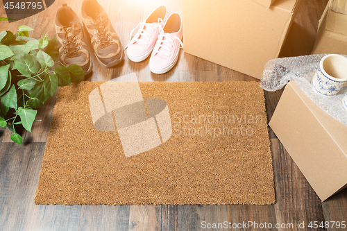 Image of Home Sweet Home Welcome Mat, Moving Boxes, Women and Male Shoes 