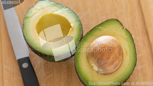 Image of Fresh Cut Avocado on Wooden Cutting Board