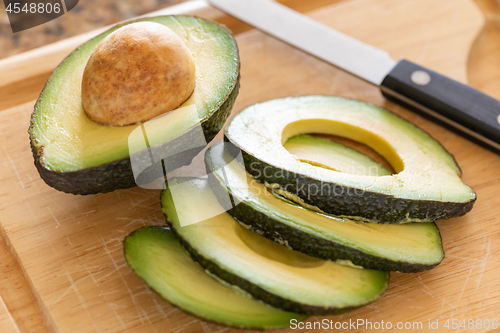 Image of Fresh Cut Avocado on Wooden Cutting Board