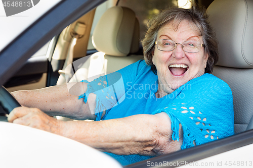 Image of Happy Senior Woman Driving New Car