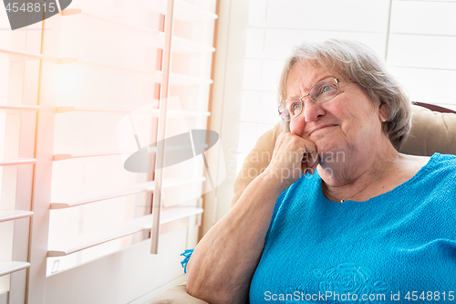 Image of Content Senior Woman Gazing Out of Her Window