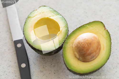 Image of Fresh Cut Avocado on Wooden Cutting Board